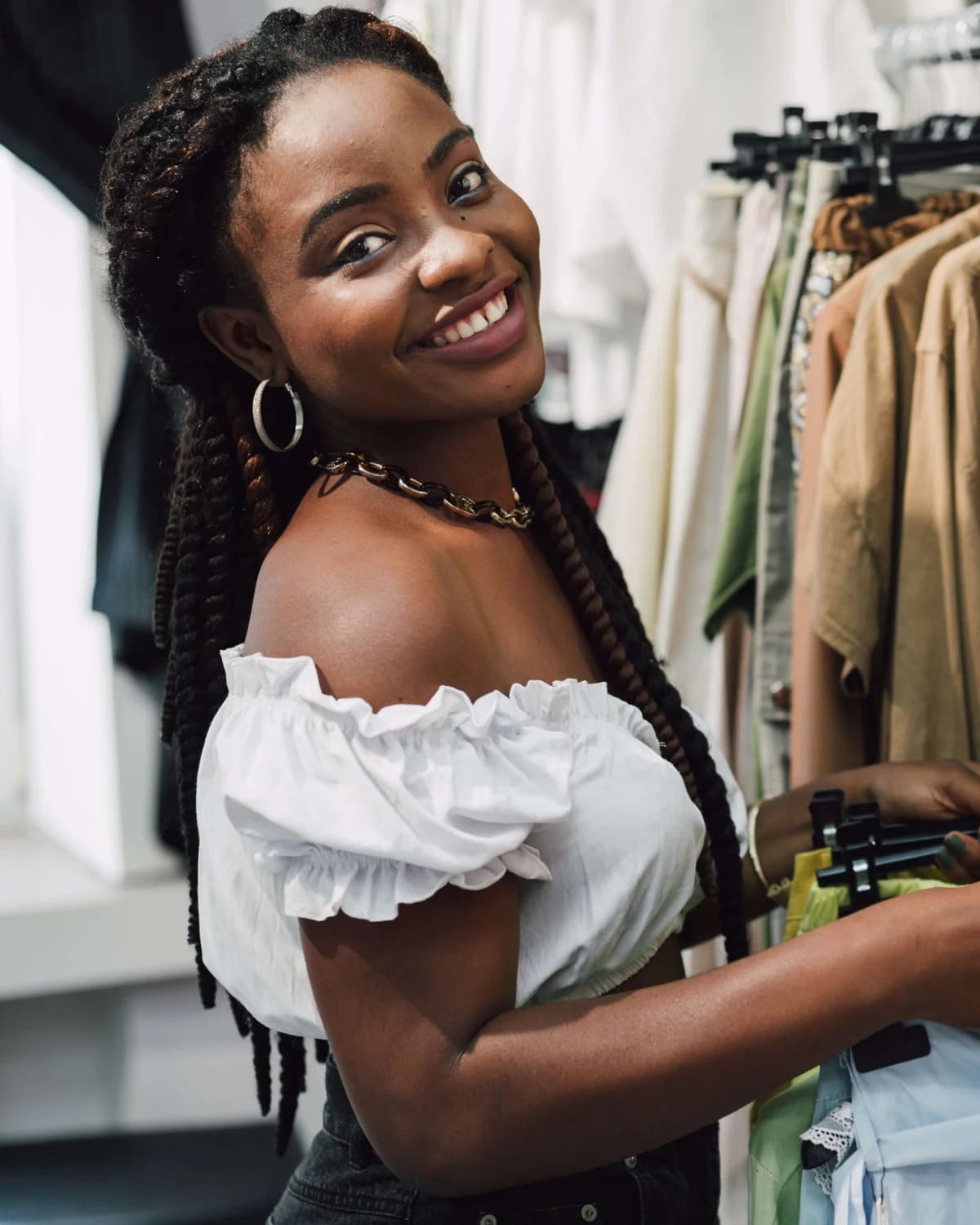 A seller smiling in her clothes shop