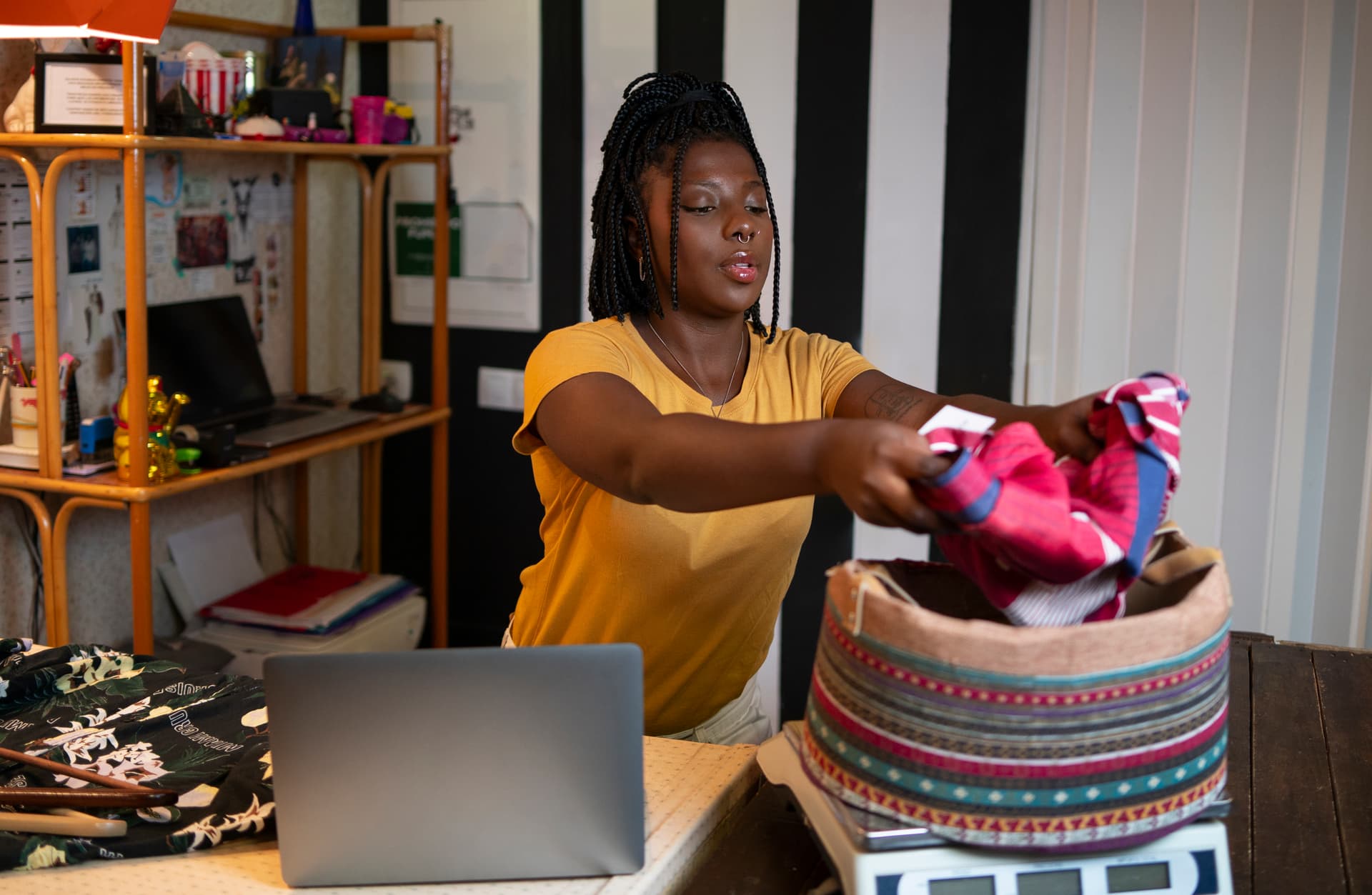 A Kenyan seller photographing stock for her online shop